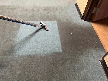 Hot water extraction wand cleaning patterned carpet with visible before and after results in Logan Utah